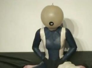 Girl With Transparent Latex Ballhood And Rubber Sheet Makes Breath Play