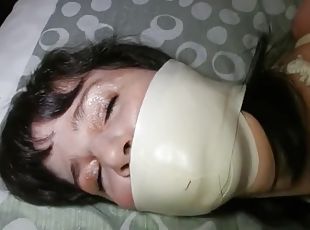 Microfoam gagged girl struggles in bondage