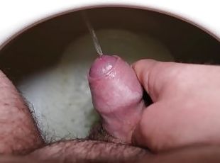 Close up of small young dick while peeing into toilet