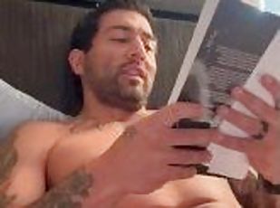 Tattooed sexy man with big enough dick does some naughty reading in the morning.