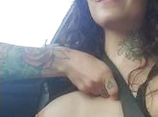 Cute Brunette with tattoos flashing her small boobs in a car